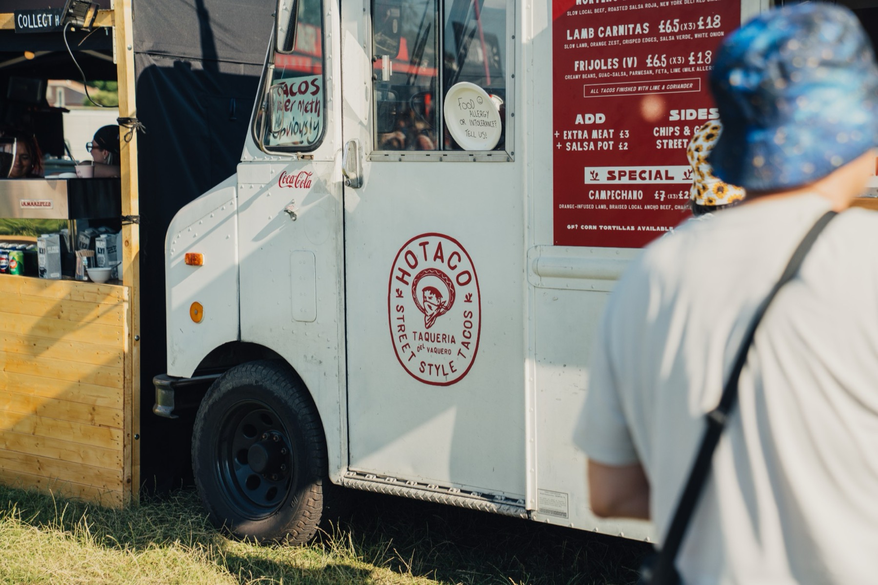 The side of the HoTaco step van showing the Taqueria del Vaquero roundel and the menu board.