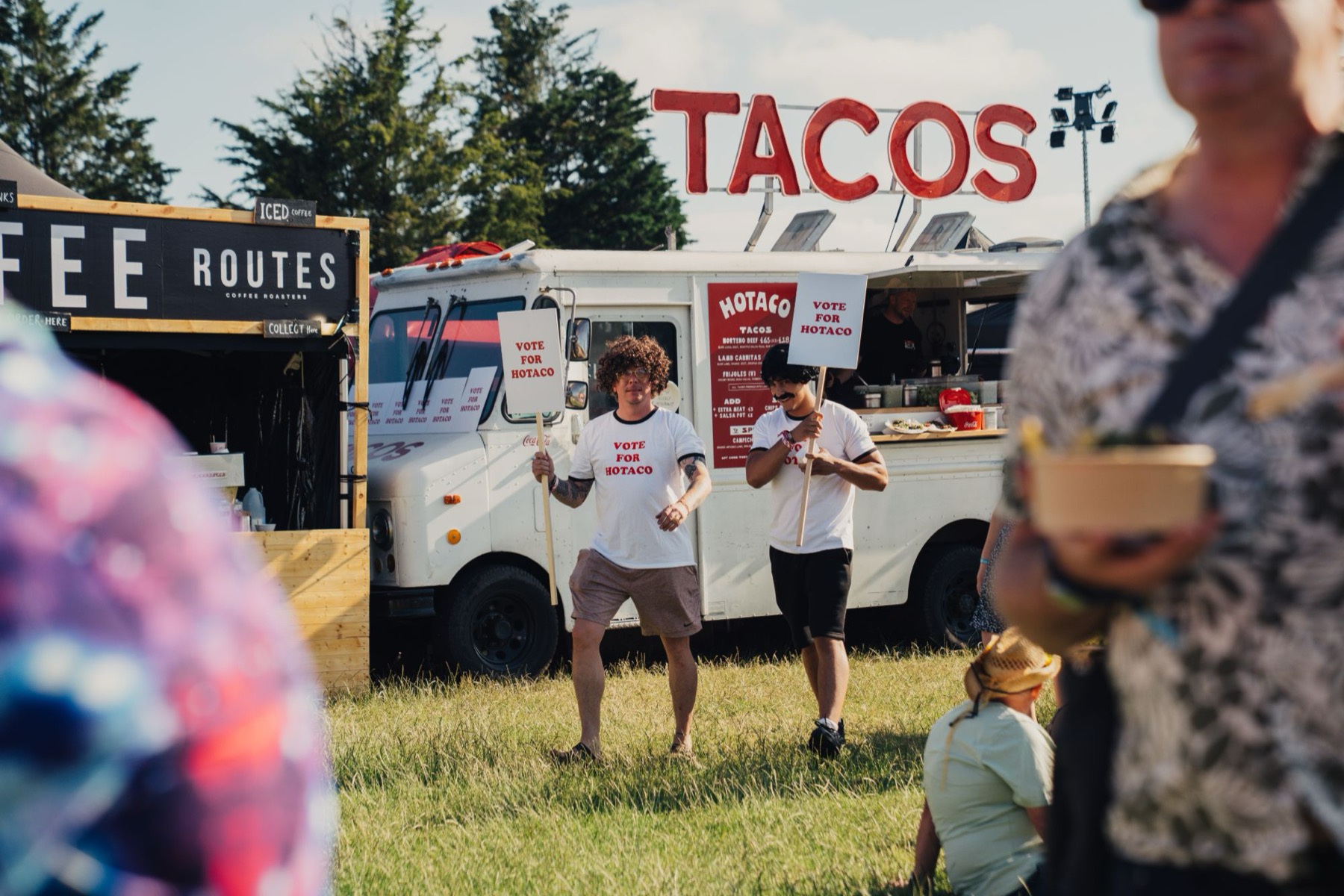 Two of the crew in Vote For HoTaco shirts working the crowd in front of the truck.
