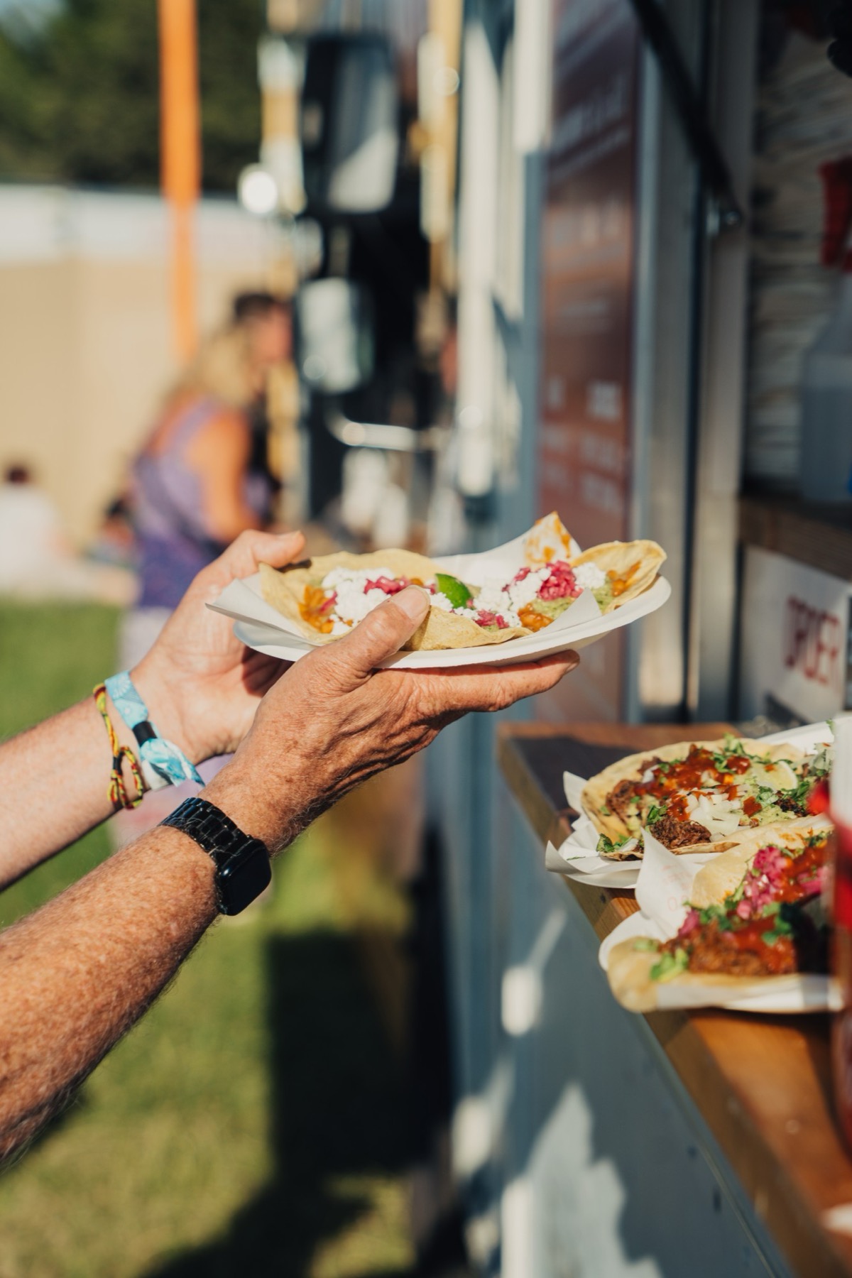 A plate of tacos handed out over the counter at the hatch.